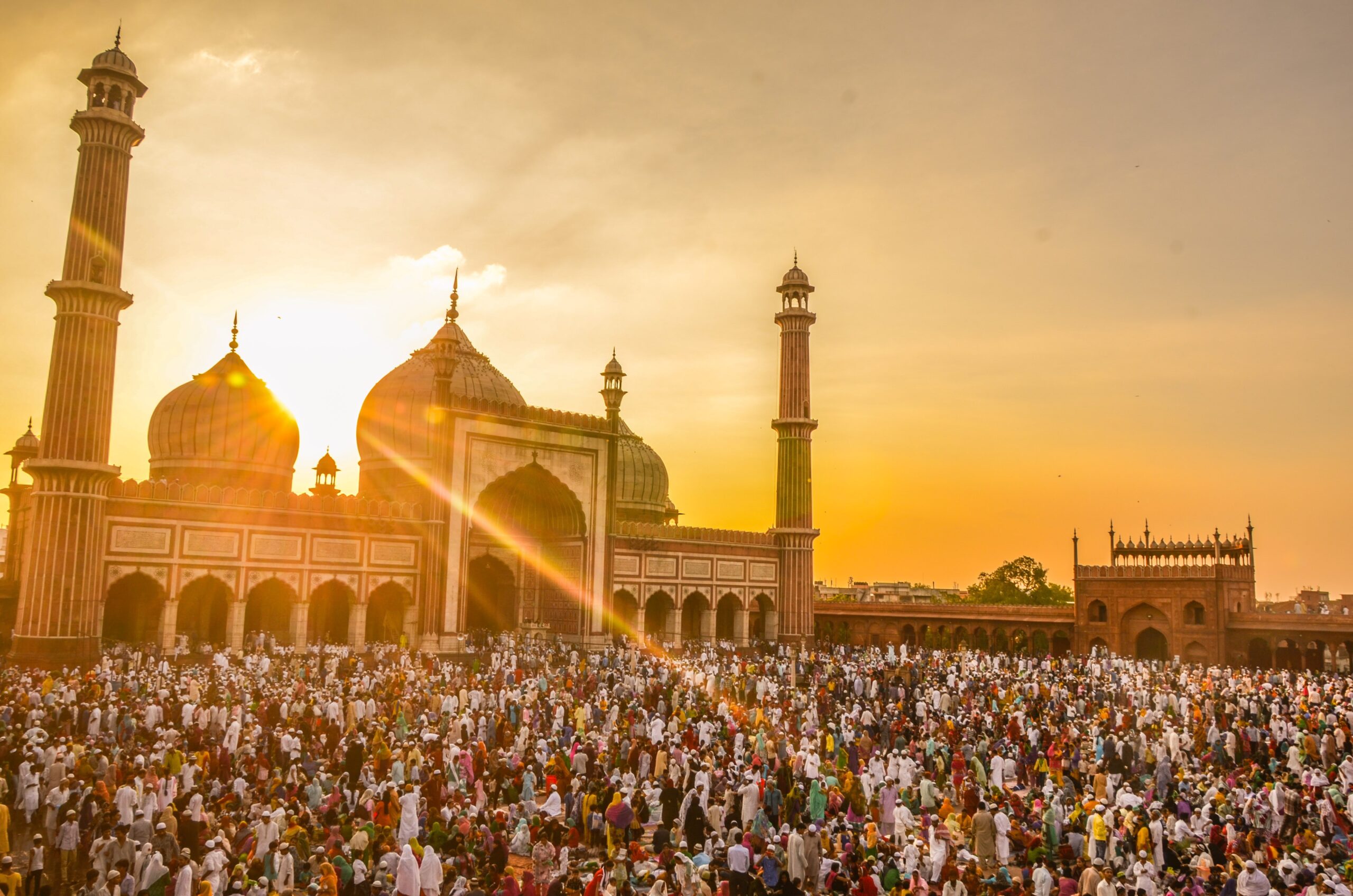 photo-of-people-in-front-of-mosque-during-golden-hour