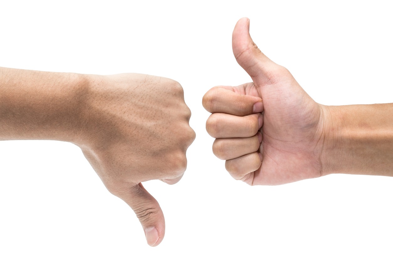 Thumb up and thumb down hand signs