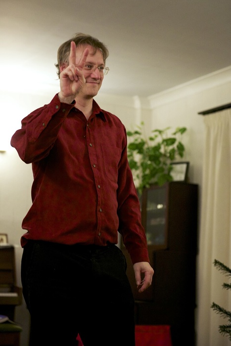 A player using two fingers to signal to his teammates that the answer has two words