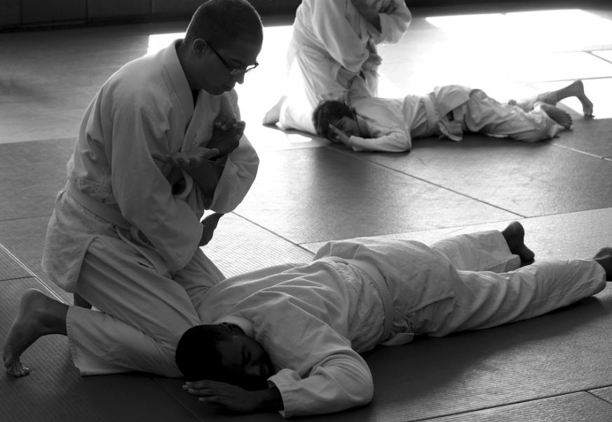 men in pairs, practicing Aikido