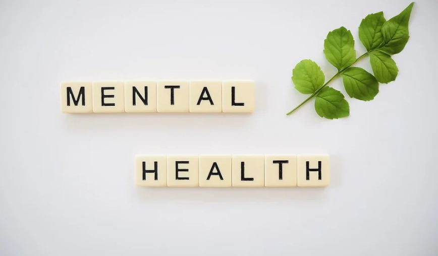 scrabble tiles arranged forming the words MENTAL HEALTH
