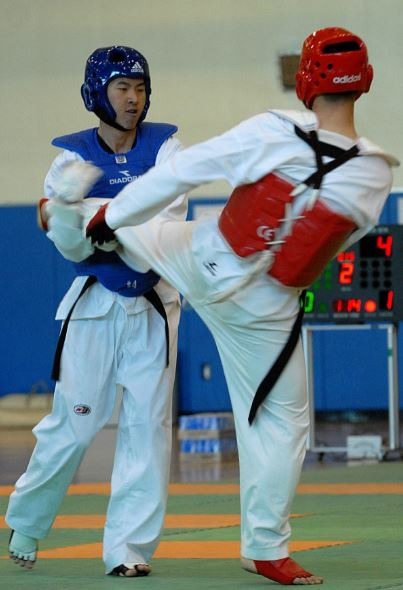 Two taekwondo practitioners wearing a headguard
