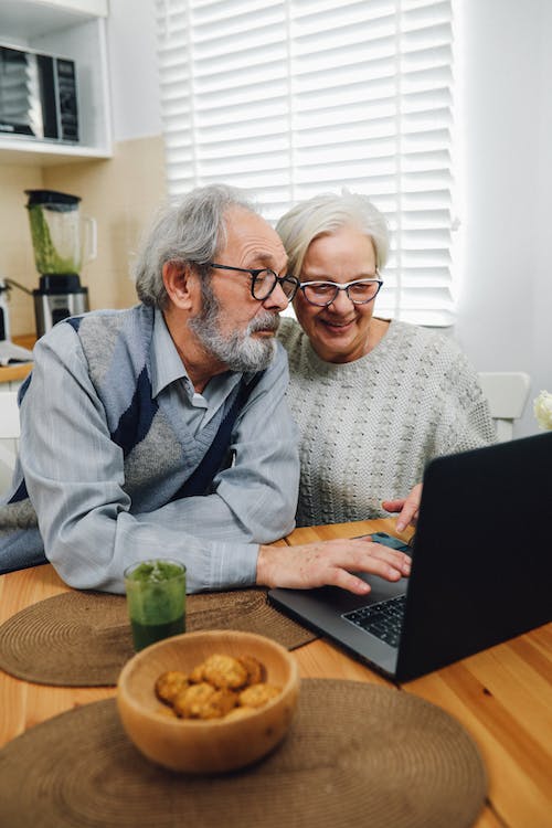Old couple using laptop