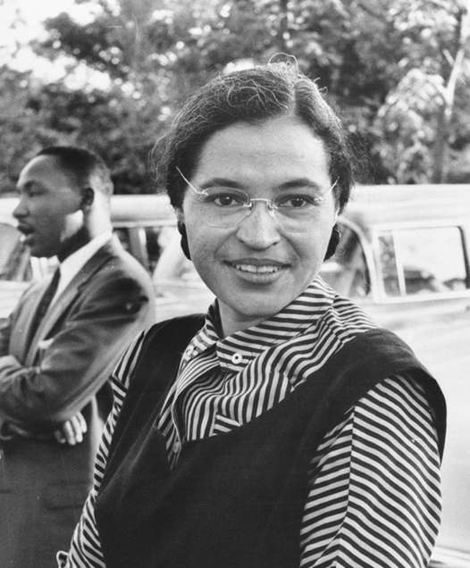 Rosa Parks in 1955, with Martin Luther King Jr. in the background